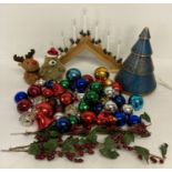 A small collection of Christmas decorations to include candle arch and baubles.
