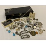 A vintage black lacquer box containing a collection of costume jewellery & mother of pearl buckles.