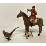 A vintage lead figure of a huntsman on a horse with beagle hunting dog.