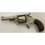 An antique 5 shot .38 Rim Fire "Conqueror" pistol with wooden grip