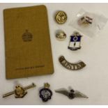 A small collection of assorted military badges, buttons & items.