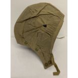A 1954 military issue tank crew canvas helmet cover, Size 3, by Cookson & Clegg Ltd.