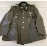 A replica WWII German SS officers Obergrupenfuhrer tunic with epaulettes and badges.