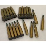 A collection of blank brass bullets. 10 x 7.62 of which 5 are in a clip.