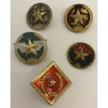 A group of 5 Vietnam War era Vietcong and N.V.A. metal helmet badges.