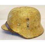 A WW2 style German Africa Corps helmet with liner and chin strap.