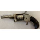 An antique .32 calibre Blue Whistler rim fire revolver with wooden grip.