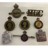 A collection of vintage military badges to include Royal Horse Guards and Women's Land army.