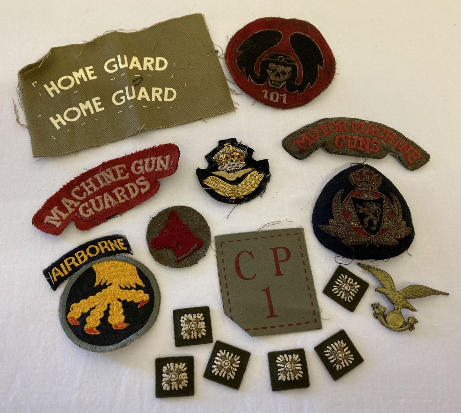 A collection of assorted military cloth badges and patches.