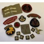 A collection of assorted military cloth badges and patches.
