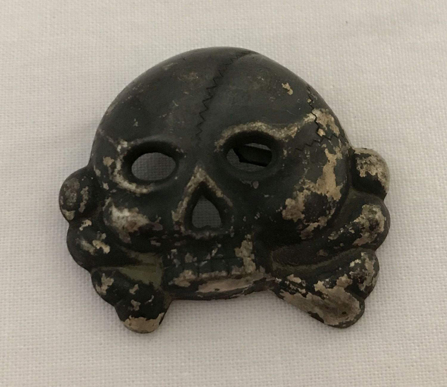 A German WWII style Allgemeine SS Totenkopf skull badge - jawless type.