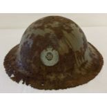 A British WWI semi relic Brodie helmet with Royal Engineers Cap badge fixed to front.
