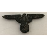 A WWII style German Waffen SS cap eagle with markings to reverse and 3 slider fixings.