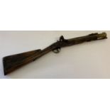 An Antique brass fixing blunderbuss with spring bayonet fixing and ram rod.