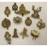 A collection of 12 assorted vintage cap badges with slider and lug fixings.