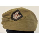 A WWII style British army side cap with hand embroidered S.A.S cap badge sewn on it.