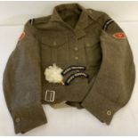 A 1960 British Army jacket with Sussex Yeomanry badges to arms and shoulders.