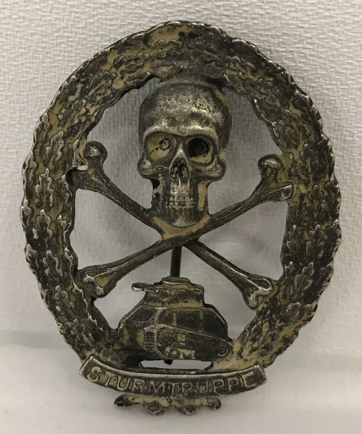 A Spanish Civil War style Austrian Storm Troops Tank Brigade pin back badge.