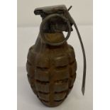 A WWII US Pineapple grenade with sprung inert metal dummy fuse.