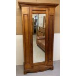 A vintage satin wood single wardrobe with mirrored door.