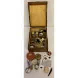 A wooden box containing a collection of mixed items.