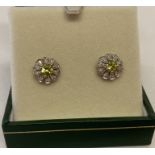 A pair of 9ct gold stud earrings set with peridots & diamonds by Luke Stockley, London