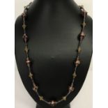 A 24" necklace with purple coloured Venetian style glass beads and gold tone screw barrel clasp.