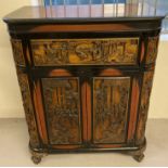 An Oriental heavily carved wooden drinks cabinet