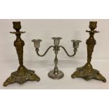 A pair of brass Italian rococo style candle sticks together with a vintage silver plate candelabra.