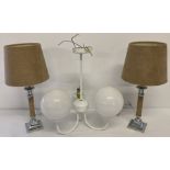 A pair of modern pale brown faux suede table lamps with shades.