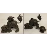 A large Chinese hollow bronze lidded censer in the form of fighting foo dogs.