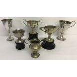A quantity of vintage winners cups and trophy's with wooden stands.