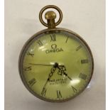 A glass ball watch, bound in brass with roman numeral markers.