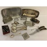 A collection of silver plate and stainless steel cutlery and table ware.