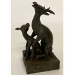 A pair of Chinese bronze seals in the form of a mother deer and her young.