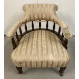 An Edwardian bow backed low nursing chair with turned detail to legs and spindles.