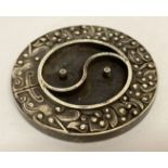 A Chinese white metal ink stone with yin and yang design to centre.