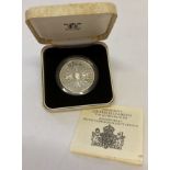 A 1980 silver proof coin commemorating the 80th birthday of The Queen Mother by Royal Mint.