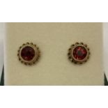 A pair of 9ct gold, garnet set stud earrings.