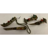 2 Tibetan white metal belt daggers set with snake skin and large pieces of coral and turquoise.