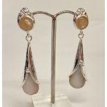 A pair of Art Nouveau style silver and pearl set earrings.