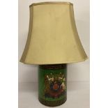 A toleware style green painted lamp base with Greek key and coat of arms detail.