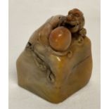 A Chinese soapstone square shaped seal with carved dragon shaped finial.