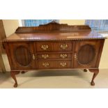 A vintage style solid wood sideboard with ball and claw feet.