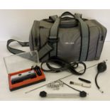 A vintage grey padded camera and gadget bag together with a boxed Kodak Instamatic camera.