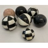 7 marble decorative balls. In varying patterns and colours, 6 large and one small.