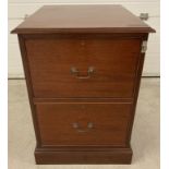 A mahogany, solid wood, 2 drawer lockable filing cabinet with drop down handles.
