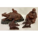 A collection of Oriental carved wooden figurines.