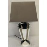 A modern Art Deco style table lamp with mirror detail.