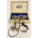 A decorative wooden box containing vintage and modern costume jewellery.